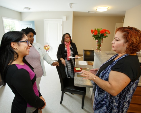 Diverse women meet and talk inside a nonprofit organization.